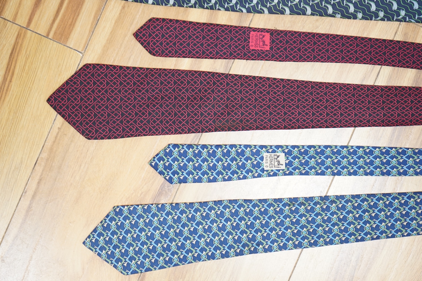 Two boxed Hermes silk scarves comprising ‘Real Escuela Andaluza del Arte Equestre’ and ‘Equateur’, with original boxes, together with four Hermes gentleman’s silk ties
